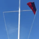 A flagpole suitable for three (3) flags