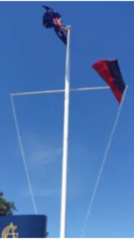 A flagpole suitable for three (3) flags